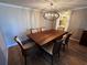 Elegant dining room featuring a wood table, six chairs, and a modern chandelier at 4119 61St Avenue W Ter # 308, Bradenton, FL 34210