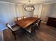 Elegant dining room with a wood table and six chairs, and a modern chandelier at 4119 61St Avenue W Ter # 308, Bradenton, FL 34210