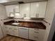 White cabinets, granite countertops, and a built-in dishwasher at 4119 61St Avenue W Ter # 308, Bradenton, FL 34210