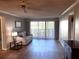 Bright living room with hardwood floors, comfy sofa, and sliding glass doors to balcony at 4119 61St Avenue W Ter # 308, Bradenton, FL 34210