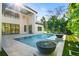 Inviting pool and spa with fire pit features and lush landscaping at 4213 W Culbreath Ave, Tampa, FL 33609