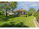 Spacious backyard with lush lawn, mature trees, and a screened porch, perfect for outdoor enjoyment at 4316 Callista Ln, Sarasota, FL 34243