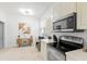 Well-lit kitchen featuring stainless steel appliances, modern lighting, and sleek countertops at 4316 Callista Ln, Sarasota, FL 34243