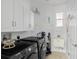Well-organized laundry room with modern appliances, storage cabinets, and laundry sink at 4316 Callista Ln, Sarasota, FL 34243