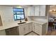 Modern kitchen with white shaker cabinets, quartz countertops, and black faucet at 4332 Pasadena Cir, Sarasota, FL 34233