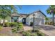 House exterior featuring a light-colored facade, gray shutters, and a paved driveway at 4711 Arpino Ct, Bradenton, FL 34211