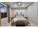 Bright bedroom with large window, plush bed, and stylish decor at 5274 Neon Ave, North Port, FL 34291