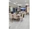 Open-concept dining and living space with stylish furnishings and abundant natural light at 5274 Neon Ave, North Port, FL 34291