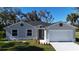 Charming single-story home featuring a well-manicured lawn, a two car garage, and tasteful landscaping at 5274 Neon Ave, North Port, FL 34291