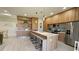 Modern kitchen with wood cabinets, stainless steel appliances, and an island at 5274 Neon Ave, North Port, FL 34291