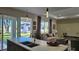 Modern kitchen with island, opens to living area and backyard view at 5274 Neon Ave, North Port, FL 34291