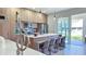 Modern kitchen with island and stainless steel appliances, backyard view at 5274 Neon Ave, North Port, FL 34291