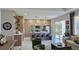 Open-concept living space featuring a modern kitchen, a seating area and sliding glass doors to a patio at 5274 Neon Ave, North Port, FL 34291
