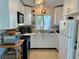 Bright kitchen with white cabinets and modern appliances at 5453 Avenida Del Mare, Sarasota, FL 34242
