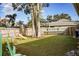 Spacious backyard with large trees, grassy area, and playground at 5715 Fern Oak Ct, Sarasota, FL 34232