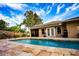 Inviting pool area with brick patio and lounge chairs at 5715 Fern Oak Ct, Sarasota, FL 34232