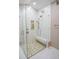 Large walk-in shower with a built-in seat and pebble floor at 5715 Fern Oak Ct, Sarasota, FL 34232