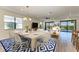 Open concept dining area with wood-look floors and a chandelier at 6043 Bluestar Ct, Bradenton, FL 34211