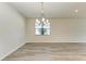 Empty dining room with wood-look floors and a chandelier at 6043 Bluestar Ct, Bradenton, FL 34211