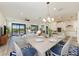 Open concept dining area with wood-look floors and a chandelier at 6043 Bluestar Ct, Bradenton, FL 34211