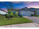 Single story home with landscaping and paver driveway at 6043 Bluestar Ct, Bradenton, FL 34211