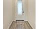Light and bright foyer with wood-look flooring and a white door at 6043 Bluestar Ct, Bradenton, FL 34211