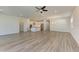 Open living room with hardwood floors and a view into the kitchen at 6043 Bluestar Ct, Bradenton, FL 34211