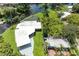 Bird's-eye view of canal-front property with pool and lush landscaping at 608 69Th W Ave, Bradenton, FL 34207