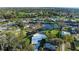 An aerial view of waterfront home with pool, beautiful landscaping, and dock along a scenic canal at 608 69Th W Ave, Bradenton, FL 34207