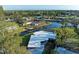 An aerial view showcases the home with dock, canal access and water views at 608 69Th W Ave, Bradenton, FL 34207