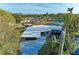Aerial view of updated waterfront property with modern carport and canal access at 608 69Th W Ave, Bradenton, FL 34207