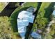 An aerial view of a modern home showing off its backyard pool and proximity to a canal at 608 69Th W Ave, Bradenton, FL 34207
