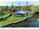 Aerial view of a backyard and waterway, showcasing a home's waterfront living and pool at 608 69Th W Ave, Bradenton, FL 34207