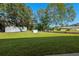 Spacious backyard with storage sheds and lush lawn near canal at 608 69Th W Ave, Bradenton, FL 34207