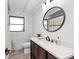 Modern bathroom with a large vanity, marble tile, and an oval mirror at 608 69Th W Ave, Bradenton, FL 34207