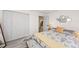 Bright bedroom featuring a large bed, built in closet and a view into the kitchen at 608 69Th W Ave, Bradenton, FL 34207