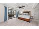 Relaxing bedroom with pool view and wood platform bed at 608 69Th W Ave, Bradenton, FL 34207