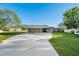Modern home exterior with carport and well-manicured lawn at 608 69Th W Ave, Bradenton, FL 34207