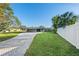 Modern home exterior with a paved driveway and landscaped lawn at 608 69Th W Ave, Bradenton, FL 34207
