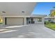 Modern garage with automatic door and covered walkway at 608 69Th W Ave, Bradenton, FL 34207