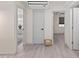 Bright hallway with light gray walls and wood-look flooring, leading to other rooms at 608 69Th W Ave, Bradenton, FL 34207