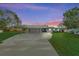 Modern house exterior with carport and manicured lawn at 608 69Th W Ave, Bradenton, FL 34207