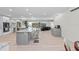 Open concept kitchen with breakfast bar, stainless steel appliances, and view to living room at 608 69Th W Ave, Bradenton, FL 34207