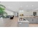 Modern kitchen with large island, stainless steel appliances, and open to living area at 608 69Th W Ave, Bradenton, FL 34207