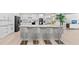 Open kitchen with gray island, white cabinets, and breakfast bar seating at 608 69Th W Ave, Bradenton, FL 34207