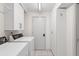 Bright laundry room with a washer, dryer, and plenty of cabinet storage at 608 69Th W Ave, Bradenton, FL 34207