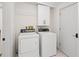 Laundry room with a washer, dryer, and additional storage cabinets at 608 69Th W Ave, Bradenton, FL 34207