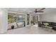 Living room with sliding doors opening to a pool and canal view at 608 69Th W Ave, Bradenton, FL 34207