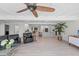 Open living room features a kitchen, L-shaped sectional sofa, and modern ceiling fan at 608 69Th W Ave, Bradenton, FL 34207