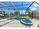 A screened-in pool and spa overlooking canal, offering a private and relaxing outdoor retreat at 608 69Th W Ave, Bradenton, FL 34207